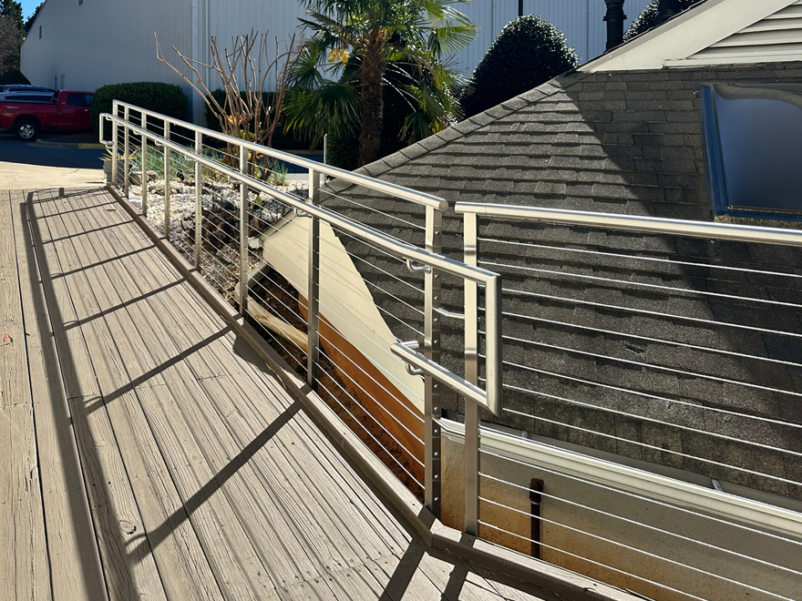 This ADA ramp slope handrail features custom railing components. The wheelchair ramp meets all ADA ramp requirements.