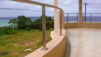 This stainless patio railing in Guam is an excellent example of a custom curved railing design. The contractor in Guam remodeled the balcony railing, patio railing, and stair railing. AGS Stainless delivered the Guam cable rail as a prefabricated kit, ready to install.