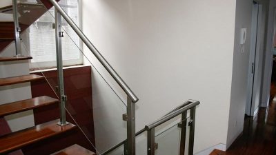 Glass rail New York, NY. This homeowner completed a staircase remodel by installing a glass panel handrail.