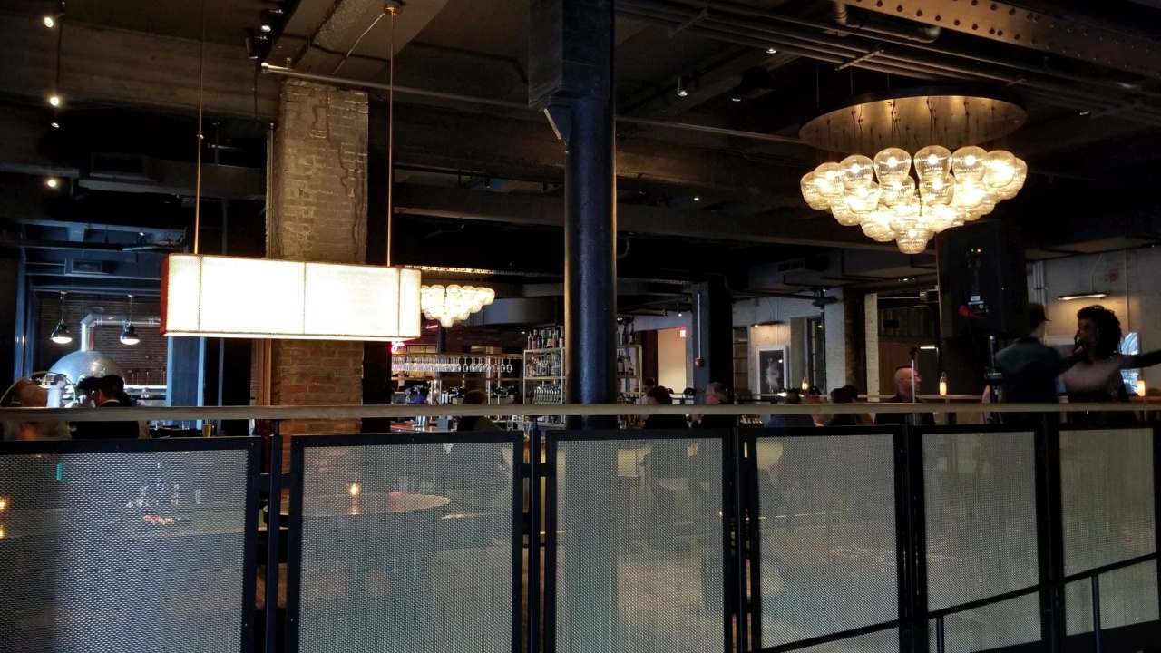 Black Powder Coated Stainless Steel "Glacier" Panel Railings with mesh infill and wood top rail | Lazia Restaurant at the Crossroads Hotel - Kansas City, KS