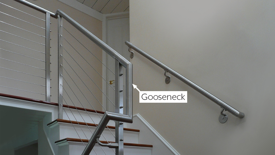 Round gooseneck handrail for transition on switchback stairs.