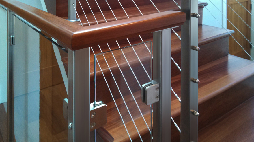 Stair railing with glass and cable infill.