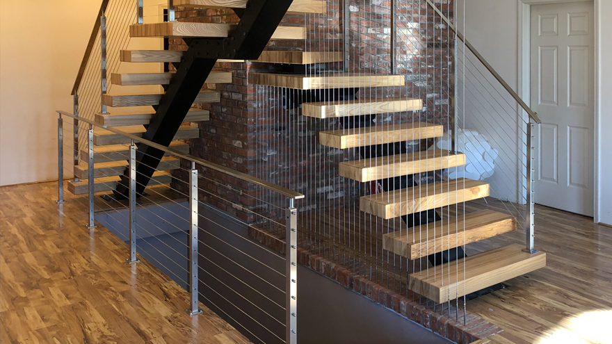 Wall created with cable. Vertical wire wall design. Staircase with wall made from cable infill.