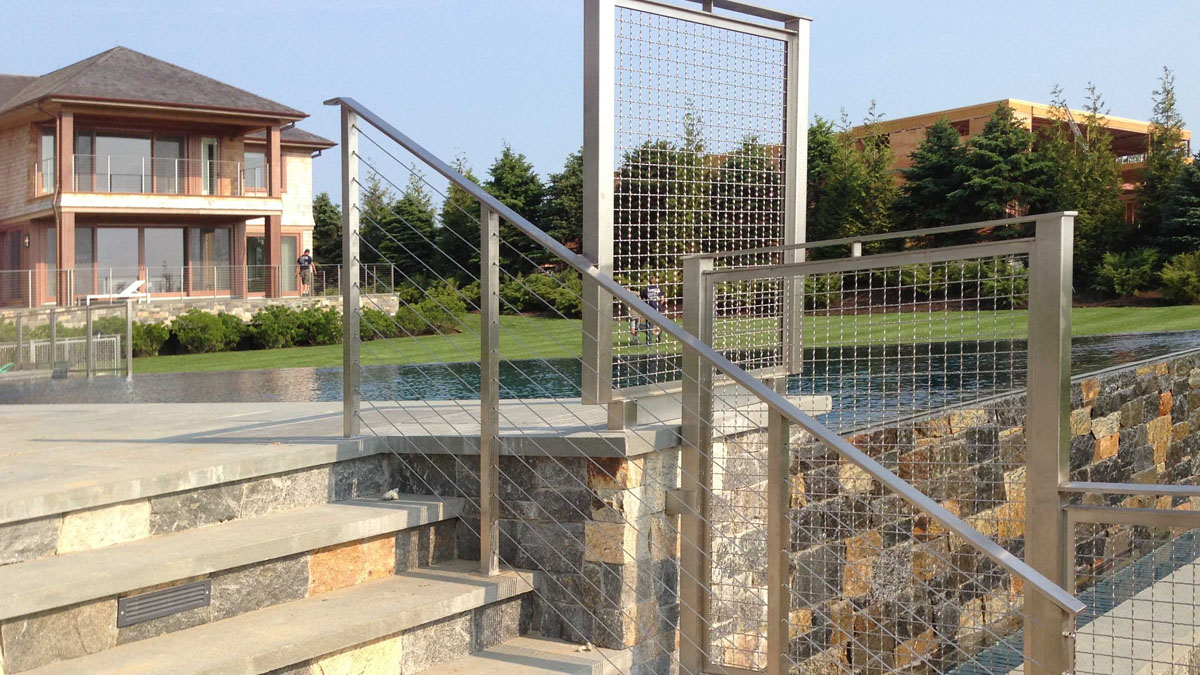 cable railing on stairs, paired with mesh panel infll