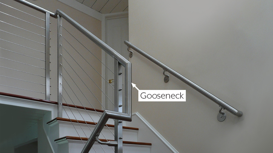 Round gooseneck handrail for transition on switchback stairs.