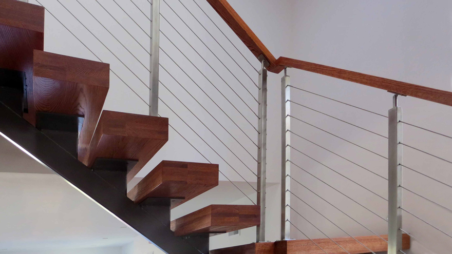 Open riser stair case with cable railing. Modern stair rail with beautiful open risers.