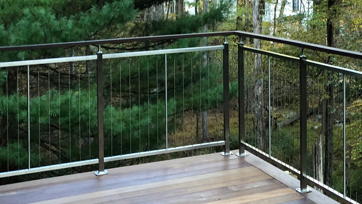 Vertical cable railing on deck with mirror finish