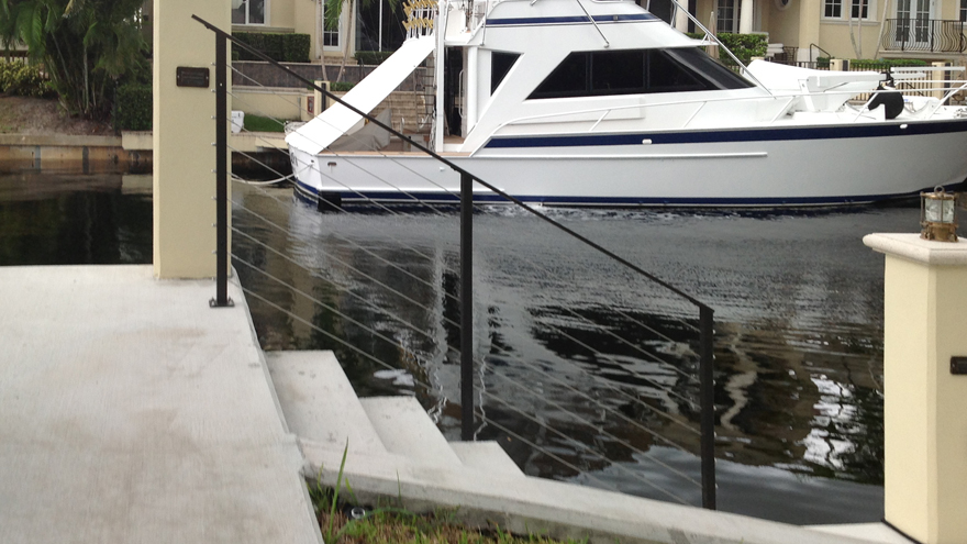 Palm beach cable railing system on stairs. Powder coat waterfront railing system.