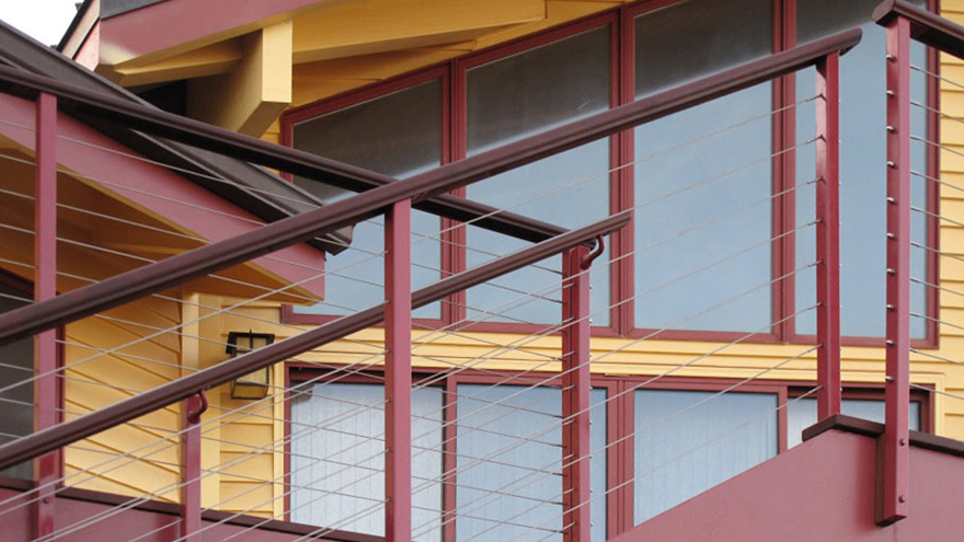 Dusk pink powder coat cable railing system on stairs.