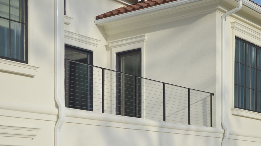 Balcony cable railing system with black powder coat railing posts.
