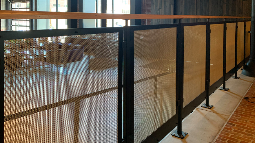 Stylish mesh panel railing system with black powder coat railing posts.