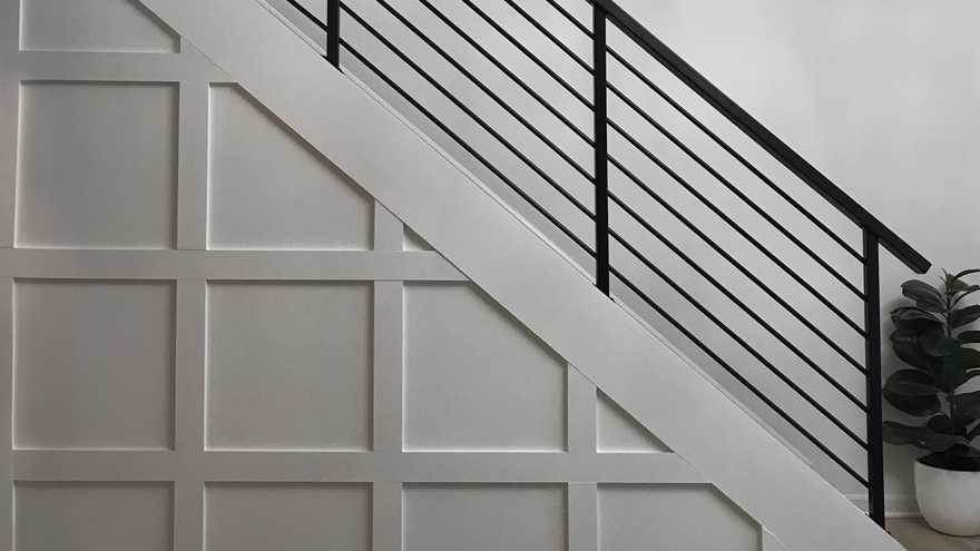 Elegant horizontal black bar stair railing system.
