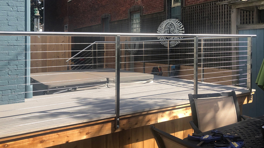 Cable railing provides a good view of the jacuzzi.