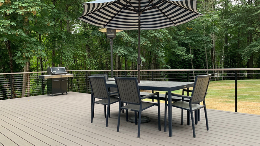 Elegant deck design includes wire railing system with black powder coat posts.