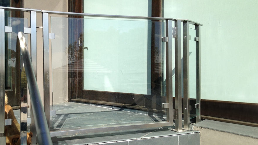 Glass panel railing system with an elegant glass gate.