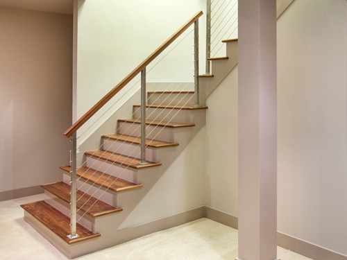 Cable railing installed on stairs. Featured in a collection of stair railing pictures. 