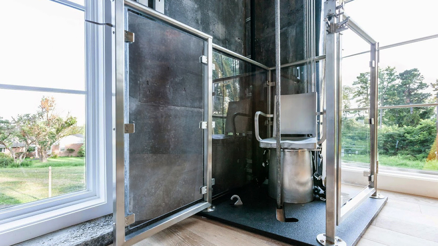 Glass panel railing forms part of a custom built elevator.