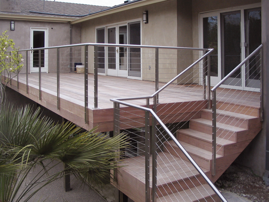 Residential deck cable railing on stairs.