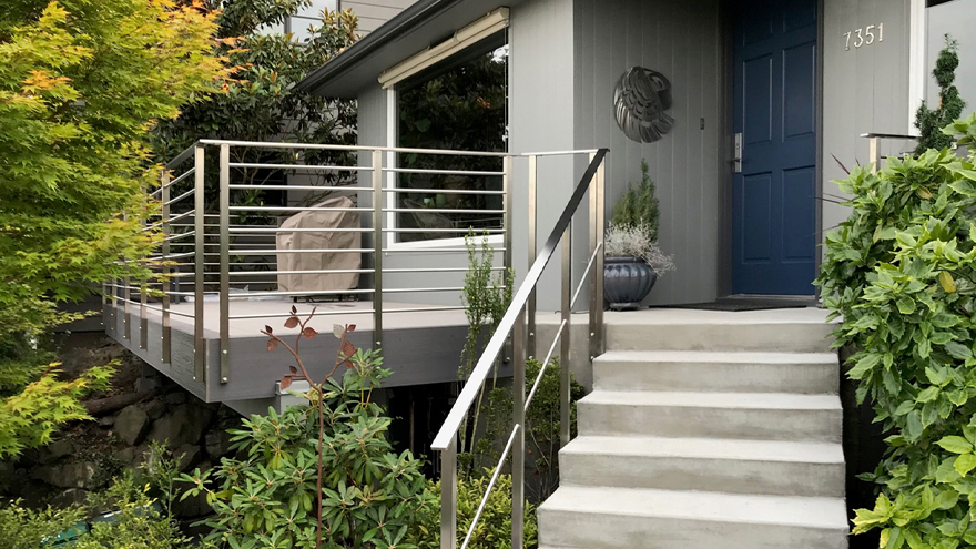 horizontal railing on concrete steps and view of side mount railing post on deck rail.