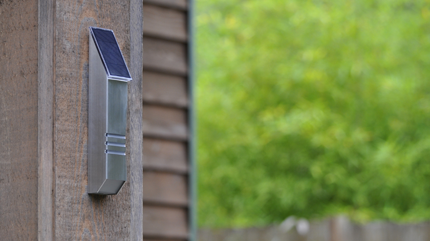 Wall-mounted solar-powered metal accent light