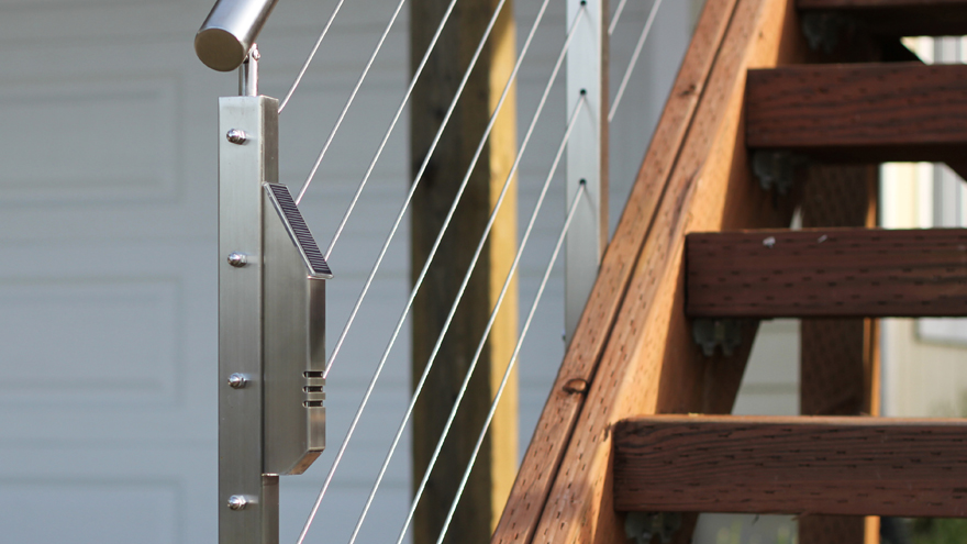 Solar-powered light mounted to railing post. The stainless steel railing lights are stylish LED solar stair lights.
