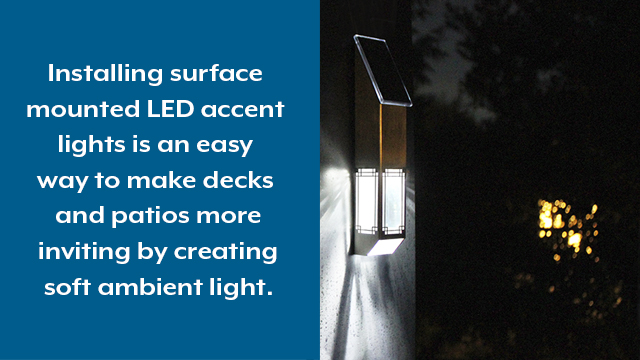 Solar-powered accent light installed to a post provides deck accent lighting.