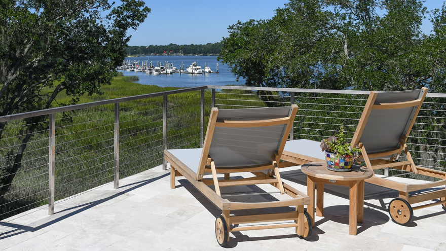 Patio handrail, cable railing with wood top rail.