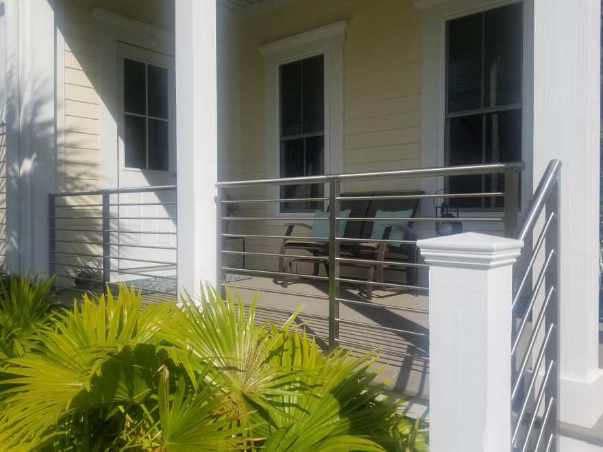 Railing for front porch blends stainless steel handrail with wood. A front porch handrail should set a good first impression.