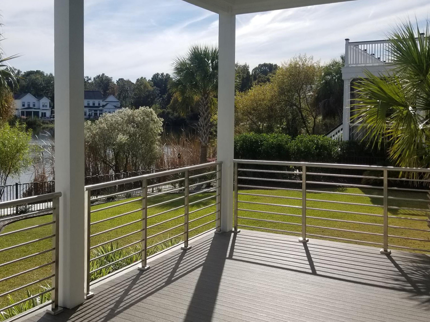 Back porch wood and stainless handrail. The mount pleasant home in SC blends wood and stainless railing to achieve a beautiful look.