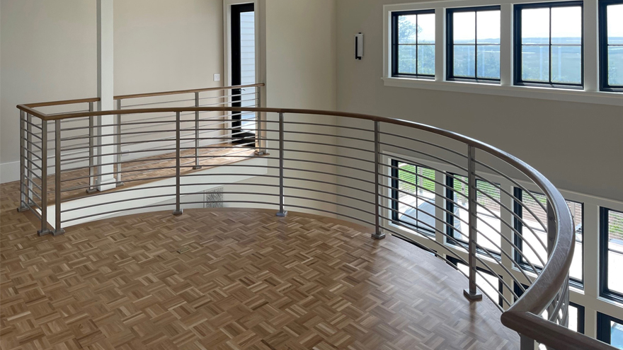 Balcony rod railing system in Charleston SC was prefabricated and shipped to the client. The curved rod railing was custom designed.