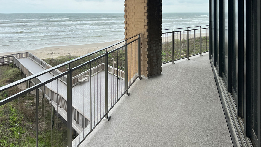 Vertical cable rail is perfect for this modern balcony rail design. The modern metal handrail mimics classic railing ideas to combine the old and the new.