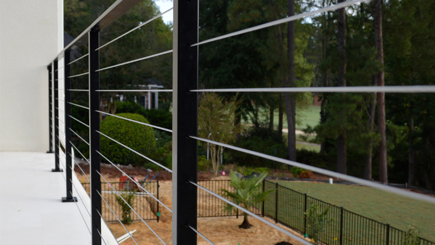 Black cable rail with black handrail and black base plate covers creates a beautifully cohesive modern rail design.