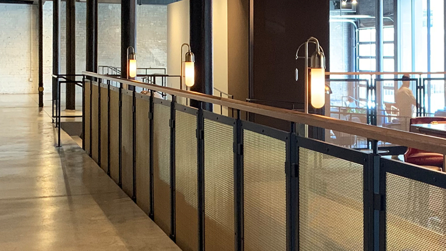 Unique interior commercial rail design installed in a restaurant. Custom railing features create a one-of-a-kind railing install.