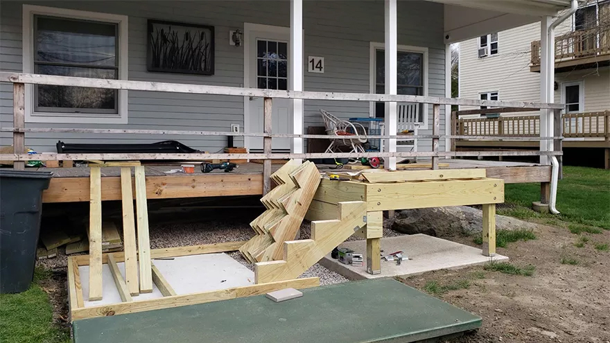 Utilizing prefabricated stair stringers and custom-built stainless railing is an efficient way to complete a deck railing project.