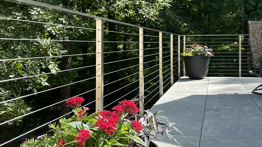Stainless deck cable railing provides a beautiful modern patio design.