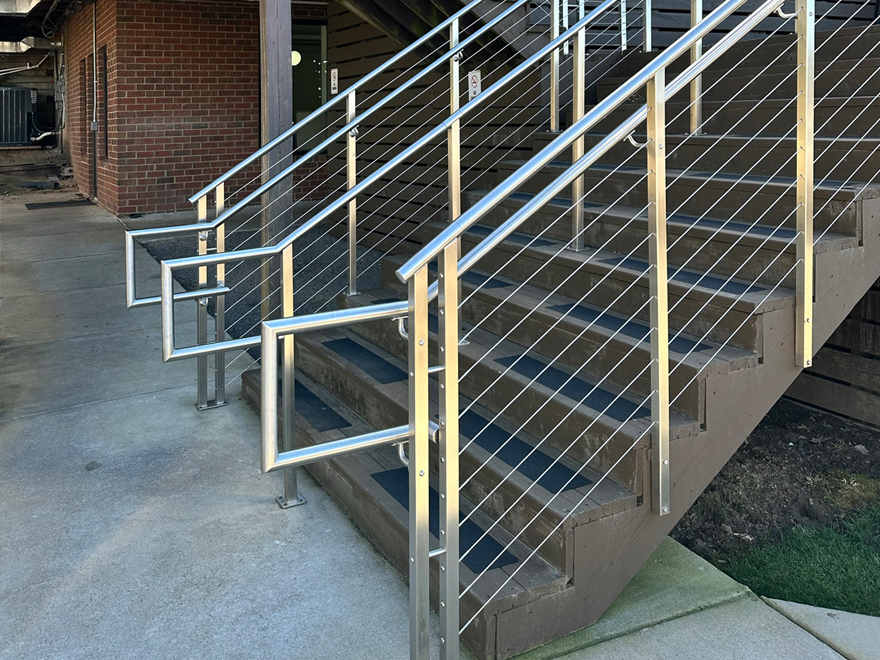 Commercial stair railing project featuring elegant handrail returns.