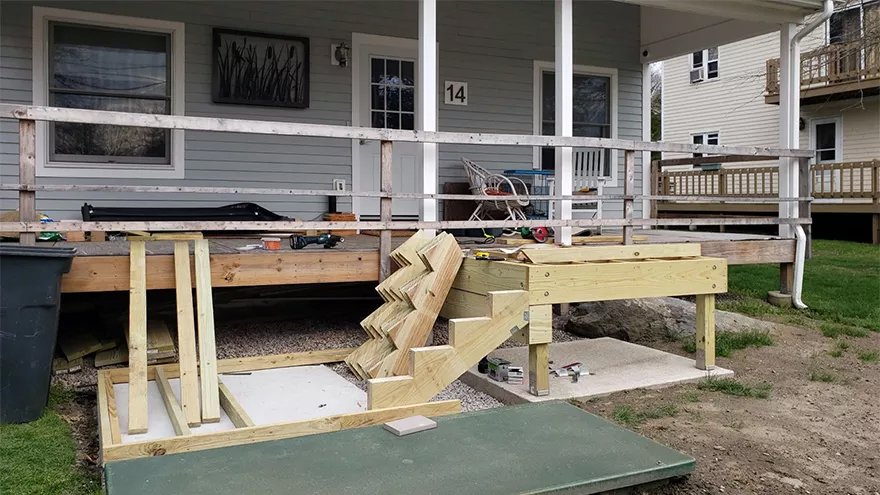 Utilizing prefabricated stair stringers and custom-built stainless railing is an efficient way to complete a deck railing project.