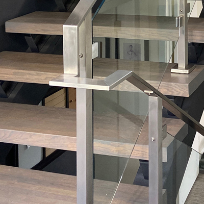 Glass railing components, such as a flat metal handrailing are custom-designed by AGS Stainless. A glass banister can be made from wood or metal depending on your preferences.