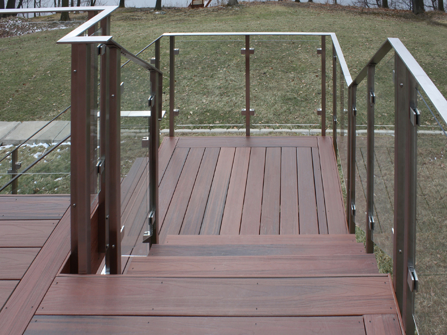 A glass railing staircase can form many configurations. Carefully selected glass deck panel railing allows you to create a unique layout.