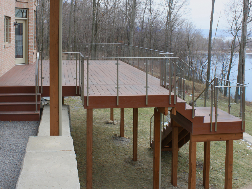 Glass decking railing systems can be surface or side-mounted. See-through deck railing is perfect for a waterfront location.