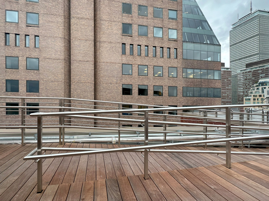 Rod railing design for commercial rooftop by AGS Stainless.