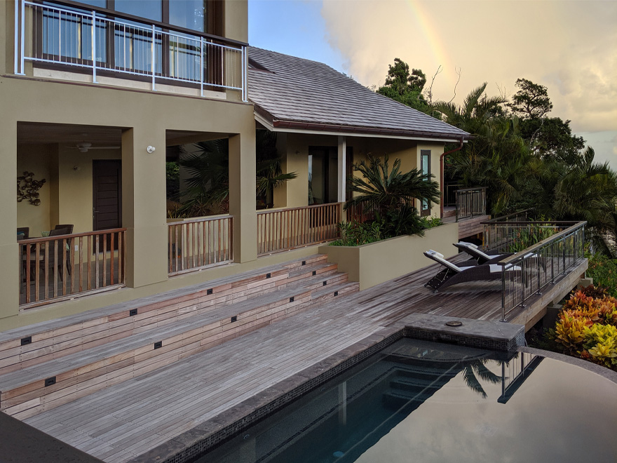 Image contrasts wooden deck pickets with stainless metal deck spindles on balcony and deck.